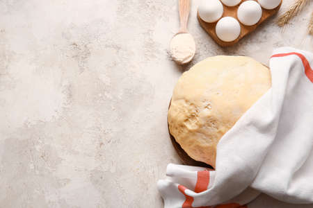Composition with fresh dough on light backgroundの写真素材