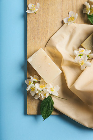 Composition with soap bars and jasmine flowers on color backgroundの写真素材