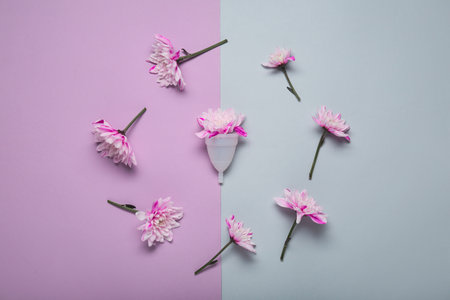 Menstrual cup and flowers on color backgroundの写真素材