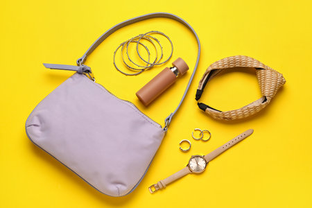 Composition with stylish handbag and different accessories on color backgroundの写真素材