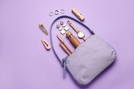 Composition with trendy handbag and different accessories on color backgroundの写真素材