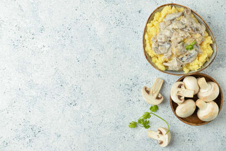 Bowl with tasty mashed potatoes and mushrooms on tableの写真素材