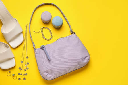 Composition with stylish handbag, shoes and different accessories on color background
