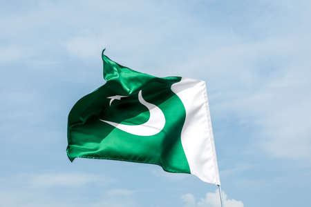 Pakistan flag outdoors against blue skyの写真素材