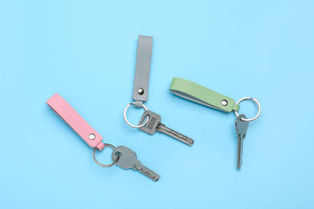 Keys with leather keychains on color backgroundの写真素材
