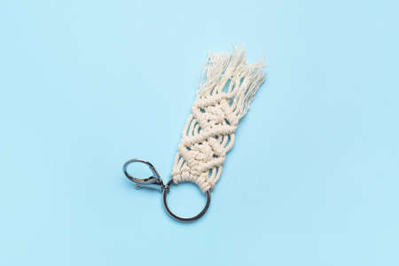 Handmade cotton keychain on color background