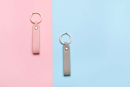 Leather keychains on color background