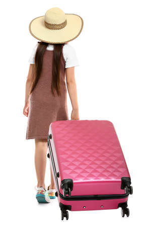 Cute little girl with suitcase on white backgroundの写真素材