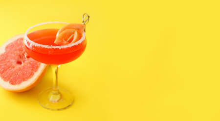 Glass of Hemingway daiquiri cocktail and grapefruit on color backgroundの写真素材