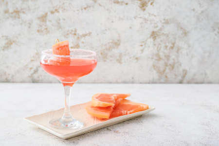 Glass of Hemingway daiquiri cocktail and grapefruit on grunge backgroundの写真素材