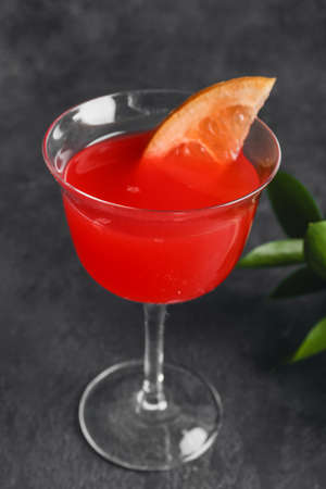 Glass of Hemingway daiquiri cocktail on dark background