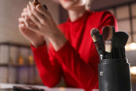 Holder with makeup brushes in dressing room, closeupの写真素材