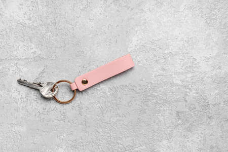 Key with leather keychain on gray backgroundの写真素材
