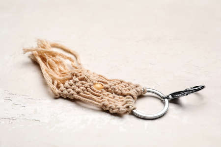 Handmade cotton keychain on light background, closeup