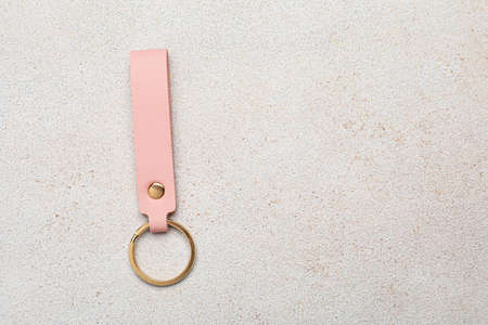 Leather keychain on light background