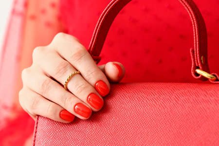 Fashionable woman with beautiful manicure holding stylish handbag, closeupの写真素材