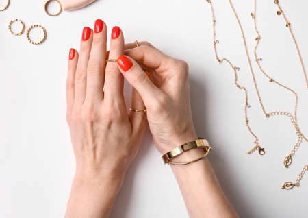 Woman with beautiful manicure and stylish jewelry on white background