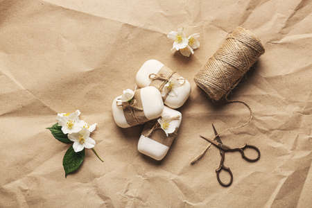 Composition with soap bars, rope and scissors on craft paper