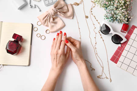 Woman with beautiful manicure and stylish accessories on white background