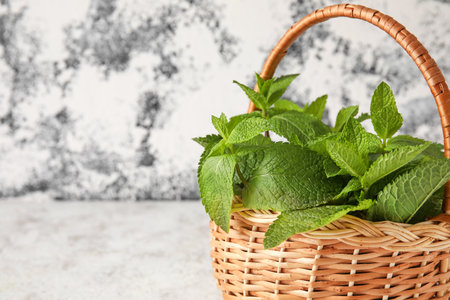 Wicker basket with mint on tableの写真素材