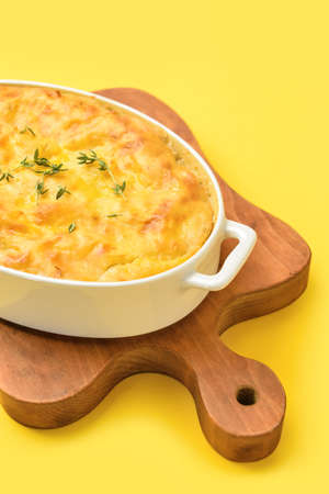 Casserole with mashed potatoes on color background, closeup