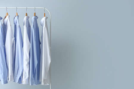 Rack with clean shirts on gray backgroundの写真素材