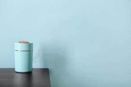 Modern humidifier on table against color background