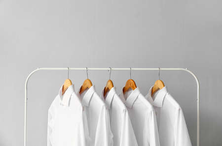 Rack with clean shirts on gray backgroundの写真素材