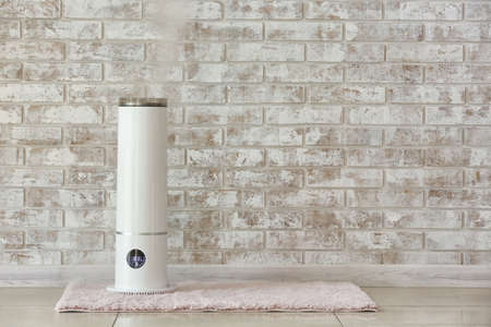 Modern humidifier near brick wallの写真素材
