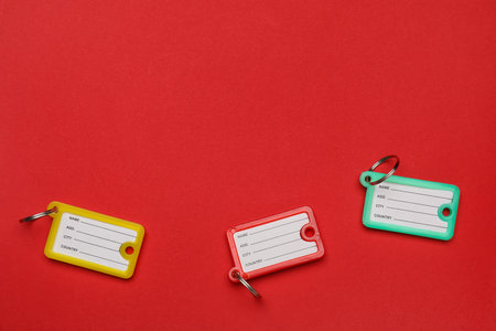Plastic key tags on color background