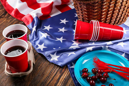American flag, dinnerware and cola drink on wooden backgroundの写真素材