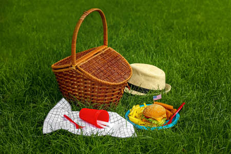 Traditional American food with picnic basket on grass in parkの写真素材