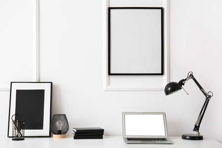 Stylish home workplace with laptop on desk