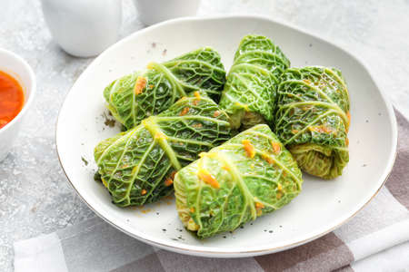 Plate with stuffed cabbage leaves on grunge background