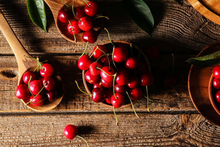 Composition with tasty ripe cherry on wooden background