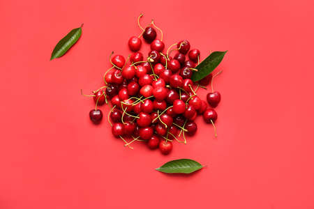 Heap of tasty ripe cherry on color background