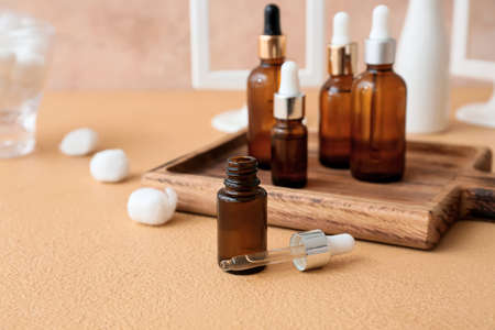 Bottle of natural essential oil on color backgroundの写真素材