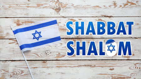 Flag of Israel and text SHABBAT SHALOM on wooden backgroundの写真素材