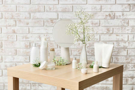 Different cosmetic products on wooden table