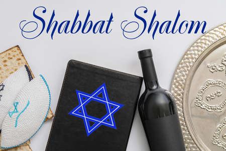 Torah, wine, Jewish cap, matza and text SHABBAT SHALOM on white backgroundの写真素材