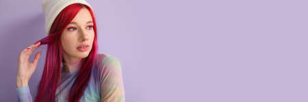 Cool young woman with bright hair on lilac background with space for text