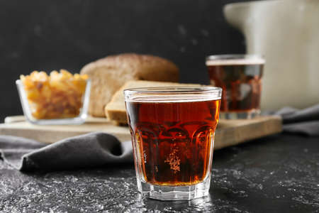 Glass of fresh kvass on dark background