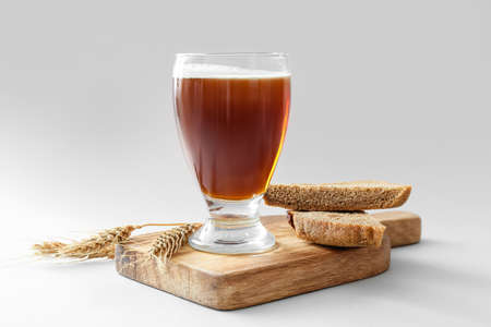 Glass of fresh kvass on light backgroundの写真素材