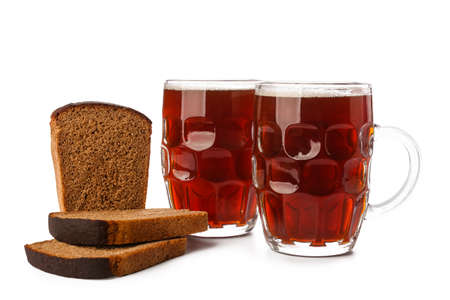 Mugs of fresh kvass and bread on white backgroundの写真素材