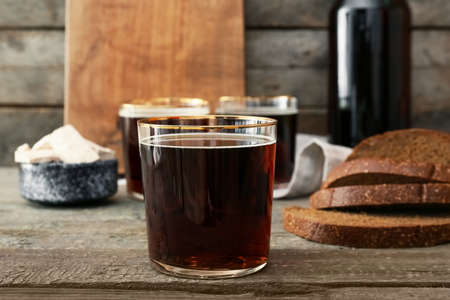 Glass of fresh kvass on wooden backgroundの写真素材