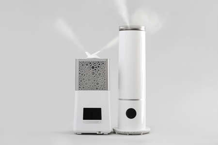 Modern humidifiers on gray backgroundの写真素材