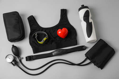 Composition with sphygmomanometer, fitness tracker and chest belt on gray backgroundの写真素材