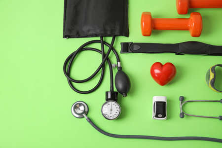 Composition with pulse oximeter, sphygmomanometer and stethoscope on color backgroundの写真素材