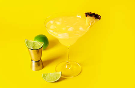 Glass of pineapple daiquiri cocktail on color backgroundの写真素材