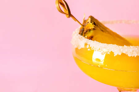 Glass of pineapple daiquiri cocktail on color backgroundの写真素材
